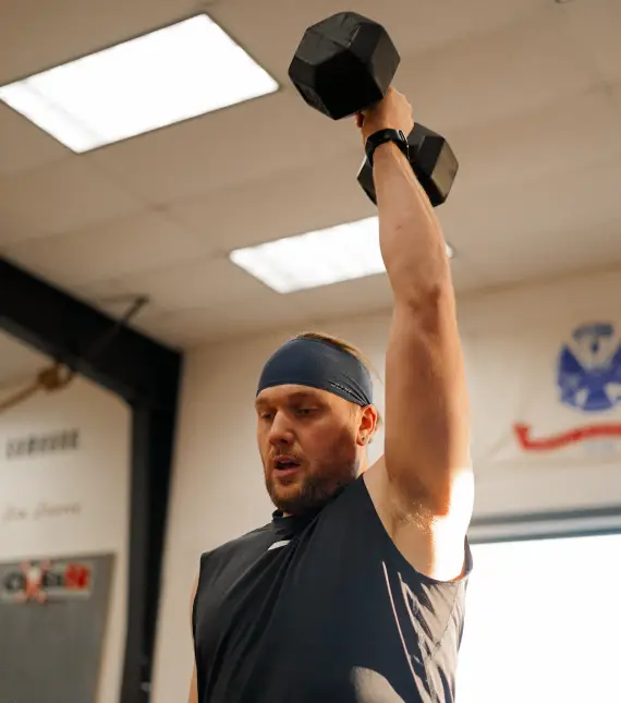 Mohawk Valley Wellness man lifting weight